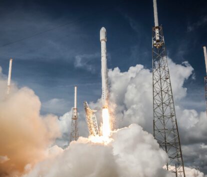 rocket launching with white smoke underneath